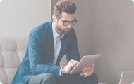 Man sitting down looking at tablet