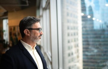 Man looking through window